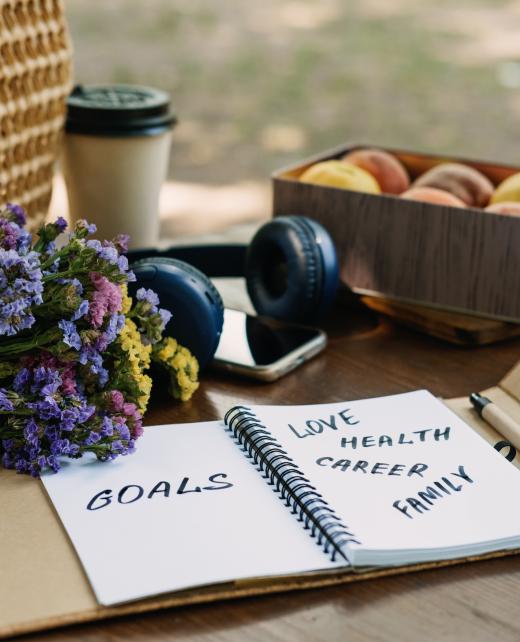 New Years Resolutions Goals motivational phrase in open notebook on the table. Outdoor still life with My Goals motivational text. Self-development and motivation.
